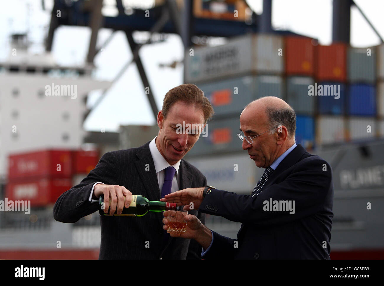 Scottish Secretary Jim Murphy (right) pours a glass of whisky with the chief executive of the Scotch Whisky Association Gavin Hewitt, as the new Scotch whisky regulations come into effect, at Grangemouth Docks, Falkirk, Scotland. Stock Photo