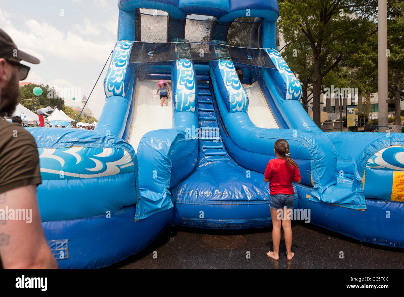 Inflatable water slide at an outdoor event - USA Stock Photo