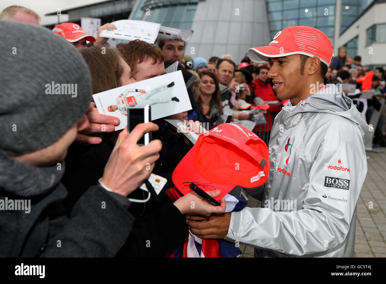 Formula One driver Lewis Hamilton of the McLaren Mercedes F1 Team signs