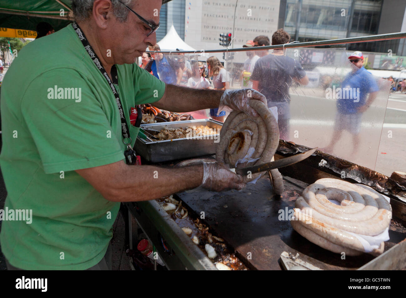 Outdoor cultural festival food vendor grilling sausages - USA Stock Photo