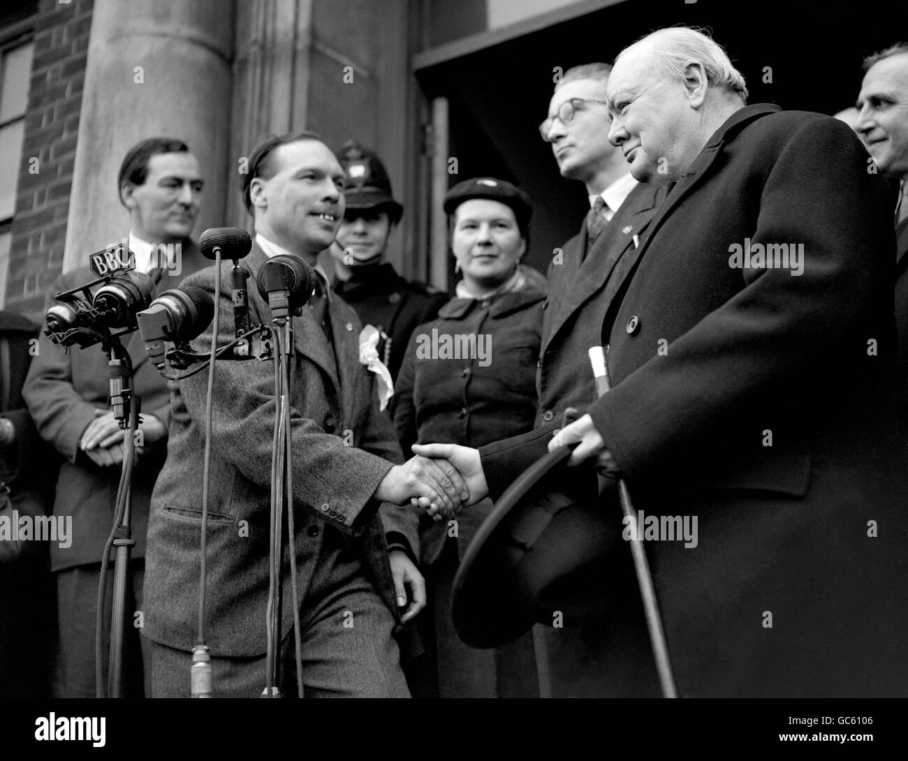 Winston Churchill (Conservatives) is congratulated by his Socialist opponent S. Hill after the declaration at Woodford. Stock Photo