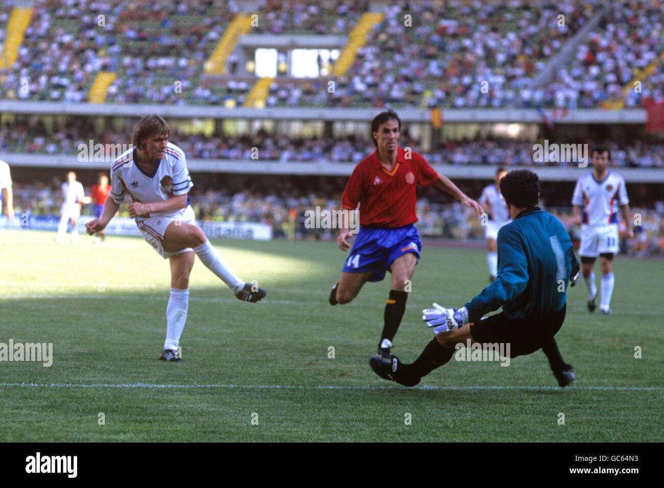 Yugoslavia's Dragan Stojkovic slots the ball past Spain goalkeeper Andoni Zubizarreta to score the opening goal of the game. Spain's Alberto Gorriz (c) can only look on. Stock Photo