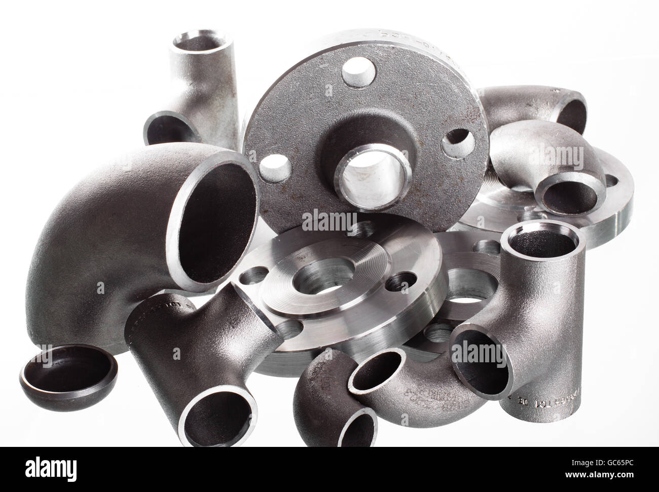 Steel welding fittings on group. Flanges, elbow, tees and plu on white space. Stock Photo