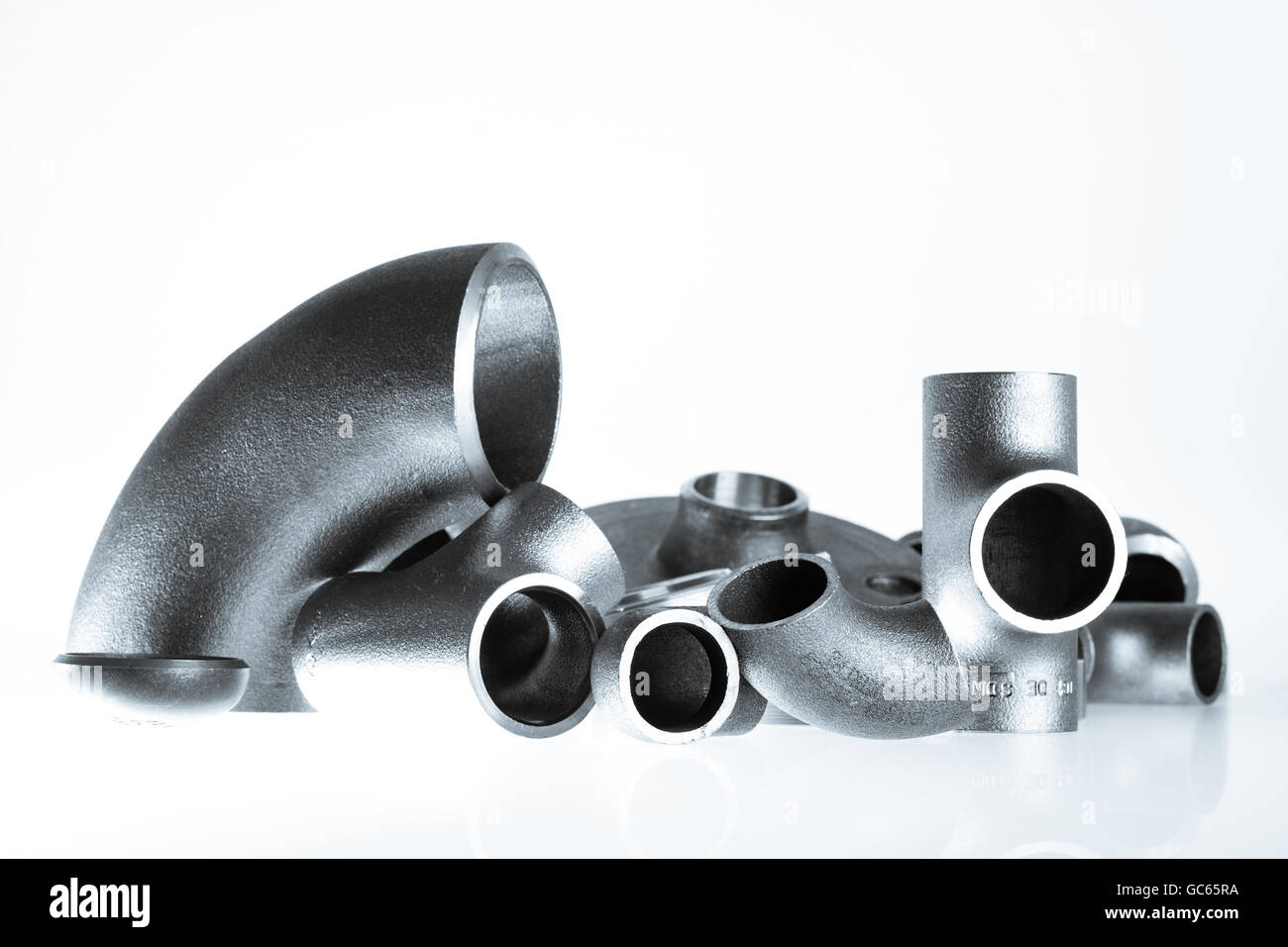 Steel welding fittings on group. Flanges, elbow, tees and plu on white