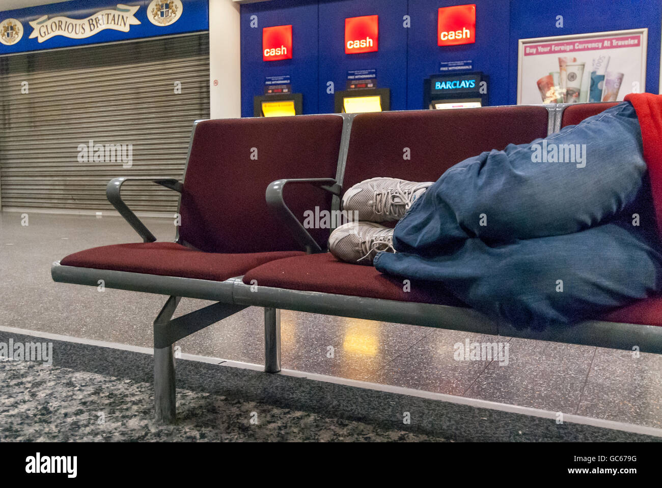 An unidentified homeless man sleeping overnight at Gatwick Airport. Stock Photo