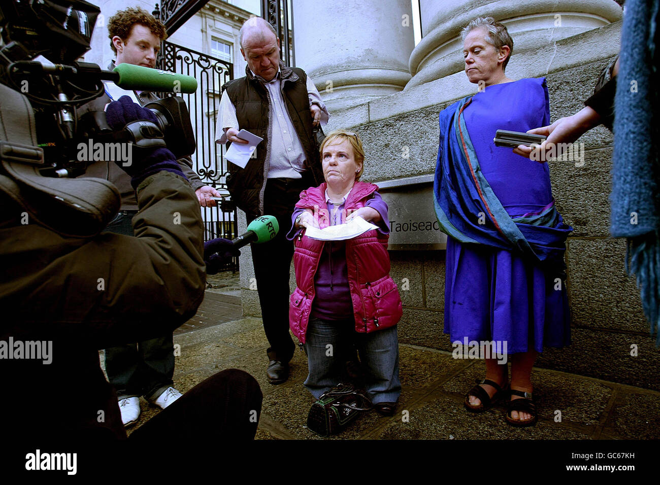 Maggie Woods (centre), chairperson of the Irish Thalidomide Association, reads out a statement to the media outside Government Buildings, Dublin, before handing in a letter addressed to Taoiseach Brian Cowen requesting a meeting with him. Stock Photo