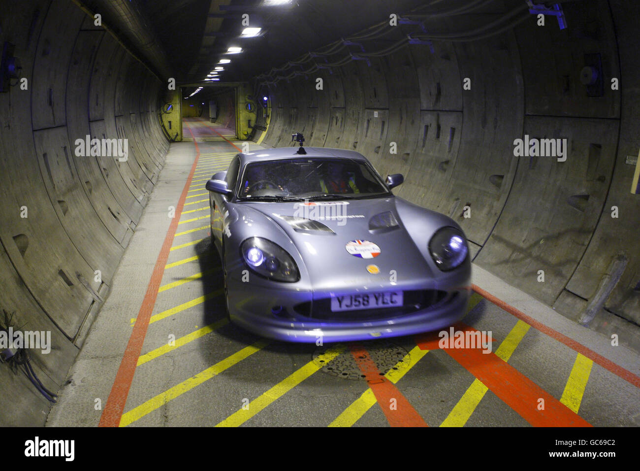 Former Formula One World Champion John Surtees nearing the end of his journey after being the first person to drive a sports car the full length of the Channel Tunnel from Folkestone in Kent to Coquelles in France. Stock Photo
