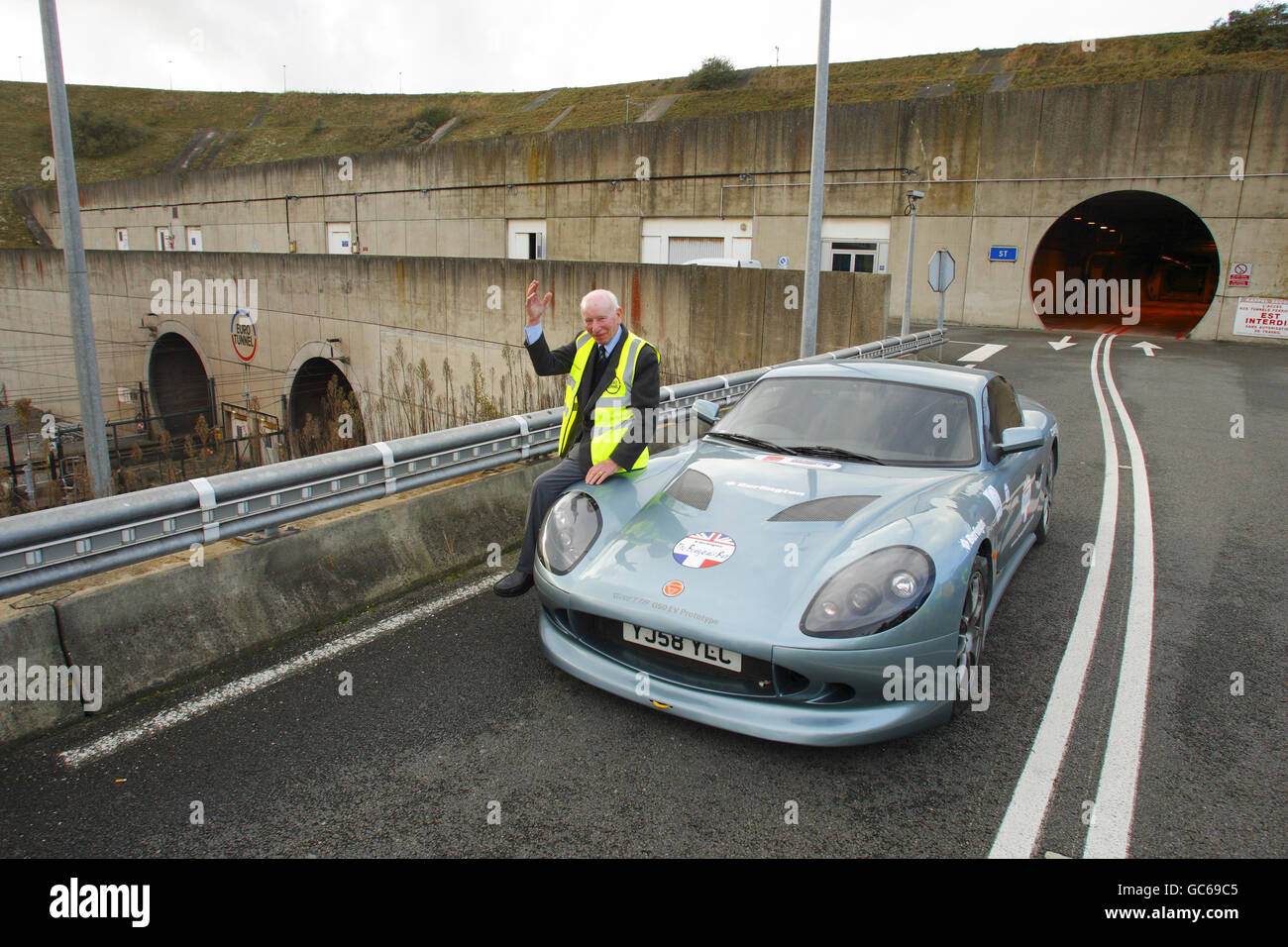 Former Formula One World Champion John Surtees after being the first person to drive a sports car the full length of the Channel Tunnel from Folkestone in Kent to Coquelles in France. Stock Photo