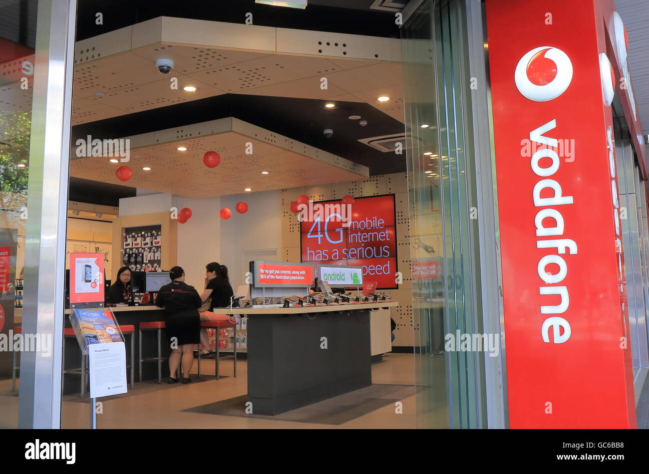 People shop at Vodafone in Melbourne Australia. Stock Photo