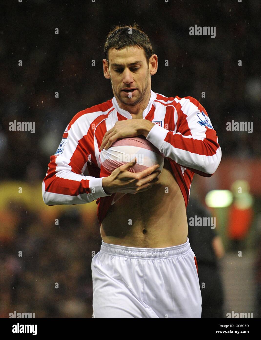 Soccer - Barclays Premier League - Stoke City v Portsmouth - Britannia Stadium. Stoke City's Rory Delap dries the ball with his shirt before launching one of his trademark throw ins Stock Photo