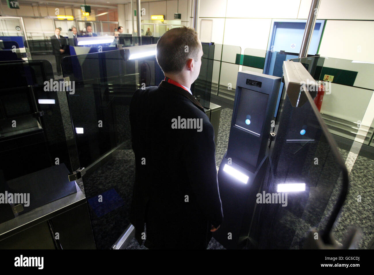 A UK Border Agency member of staff tries out the new fast track facial