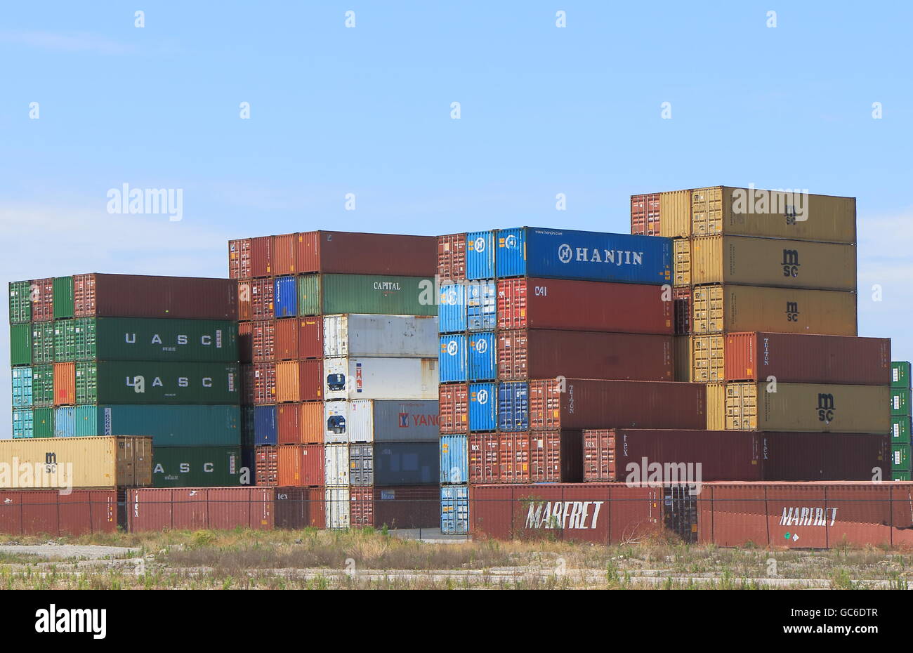 Cargo containers piled up at Port of Melbourne dock in Melbourne