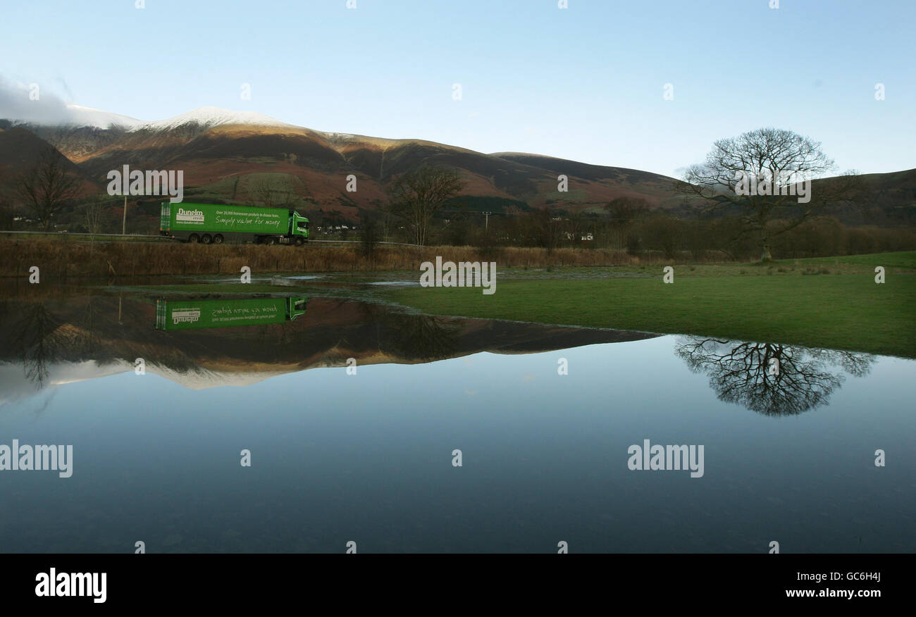 A lorry is reflected in a flooded field in Keswick in the Lake District as the flood waters that submerged large areas of Cumbria subside. Stock Photo