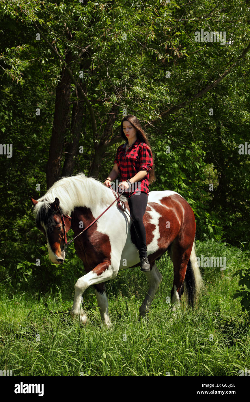 Pretty cowgirl bareback riding painted horse Stock Photo