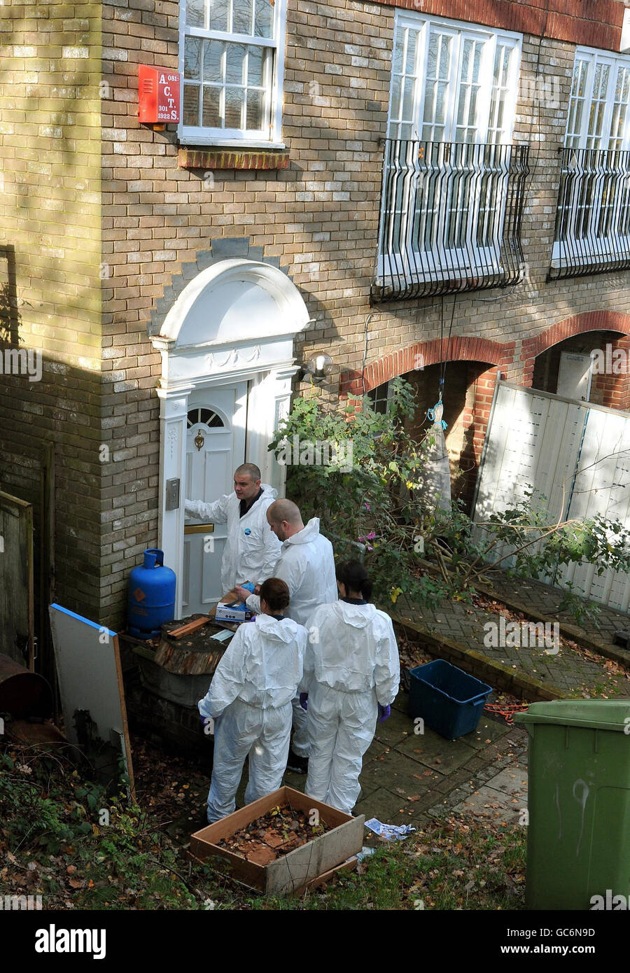 A Police forensic team prepare to enter the home of Delroy Grant 