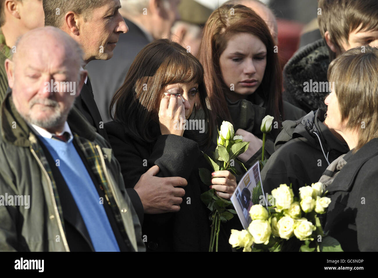 Mourners weep at a repatriation through the Wiltshire town of Wootton Bassett as the bodies of Rifleman Philip Allen, 20, of 2nd Battalion The Rifles and Samuel John Bassett, 20, of 4th Battalion The Rifles pass through the High Street. Stock Photo