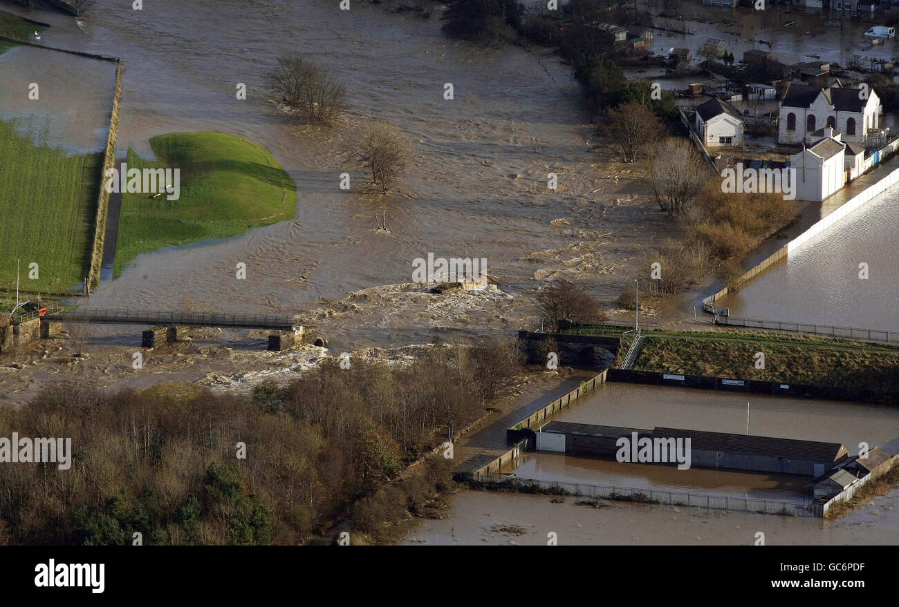 An aerial view of a destroyed bridge, in the Workington area as floods submerge large parts of Cumbria. Stock Photo