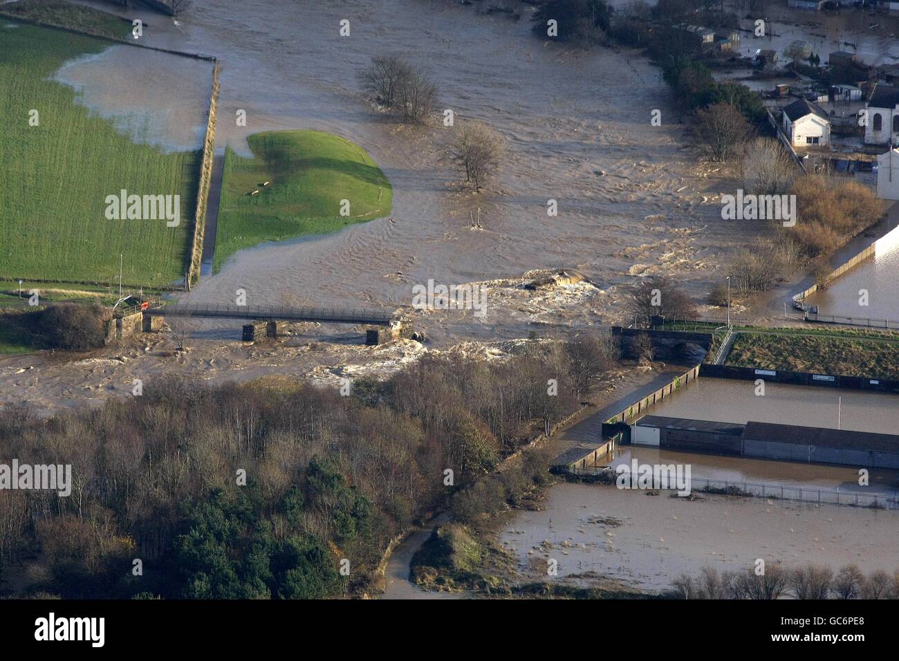 An aerial view of a destroyed bridge, in the Workington area as floods submerge large parts of Cumbria. Stock Photo
