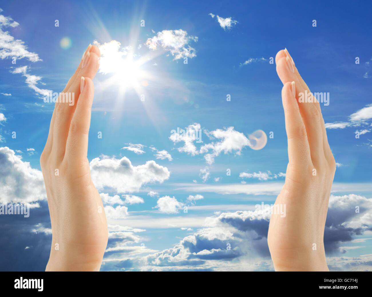 Female hands on blue sky background in closeup Stock Photo - Alamy