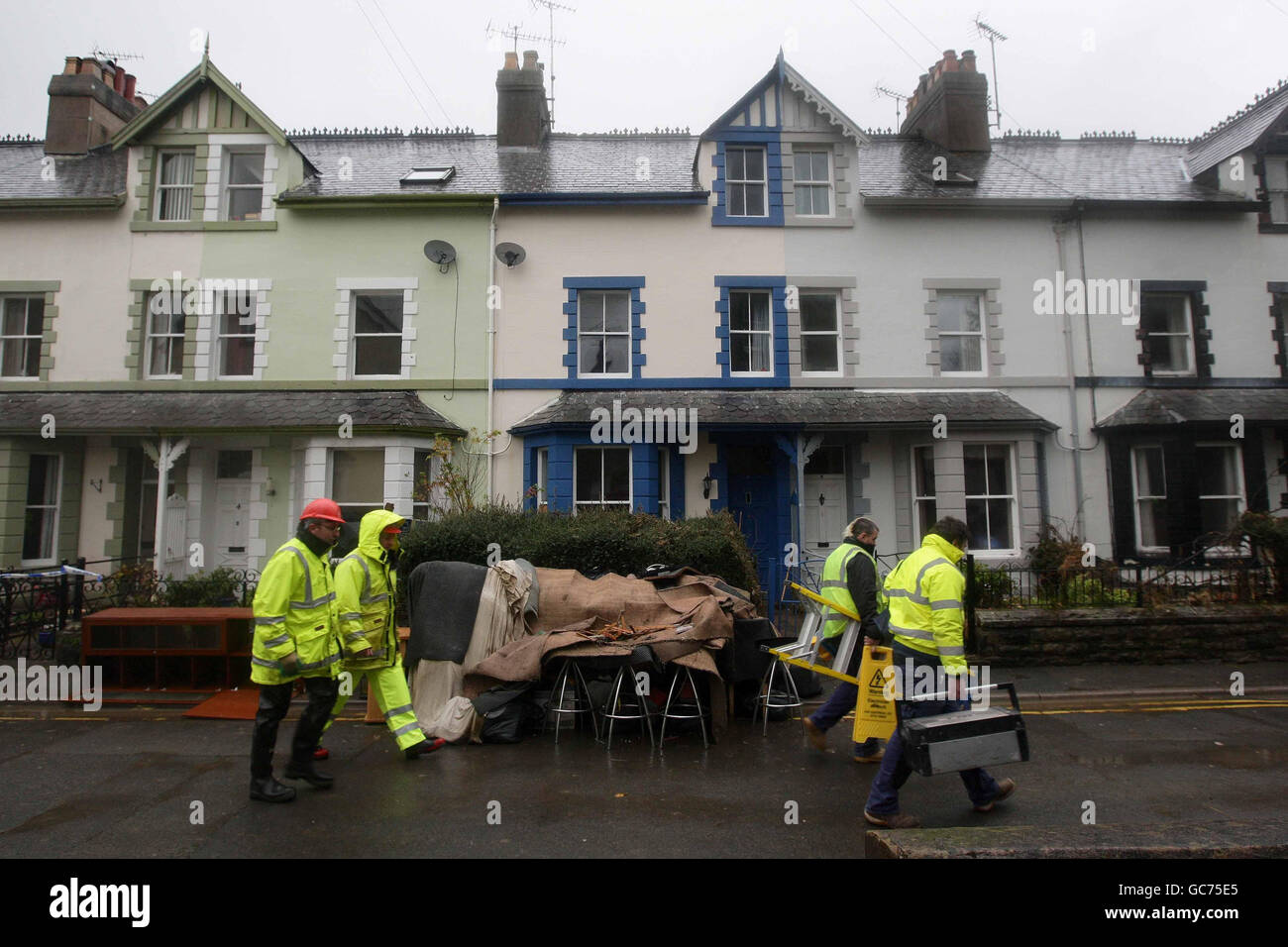 Workmen clean up part of Cockermouth town centre following the recent floods. Stock Photo