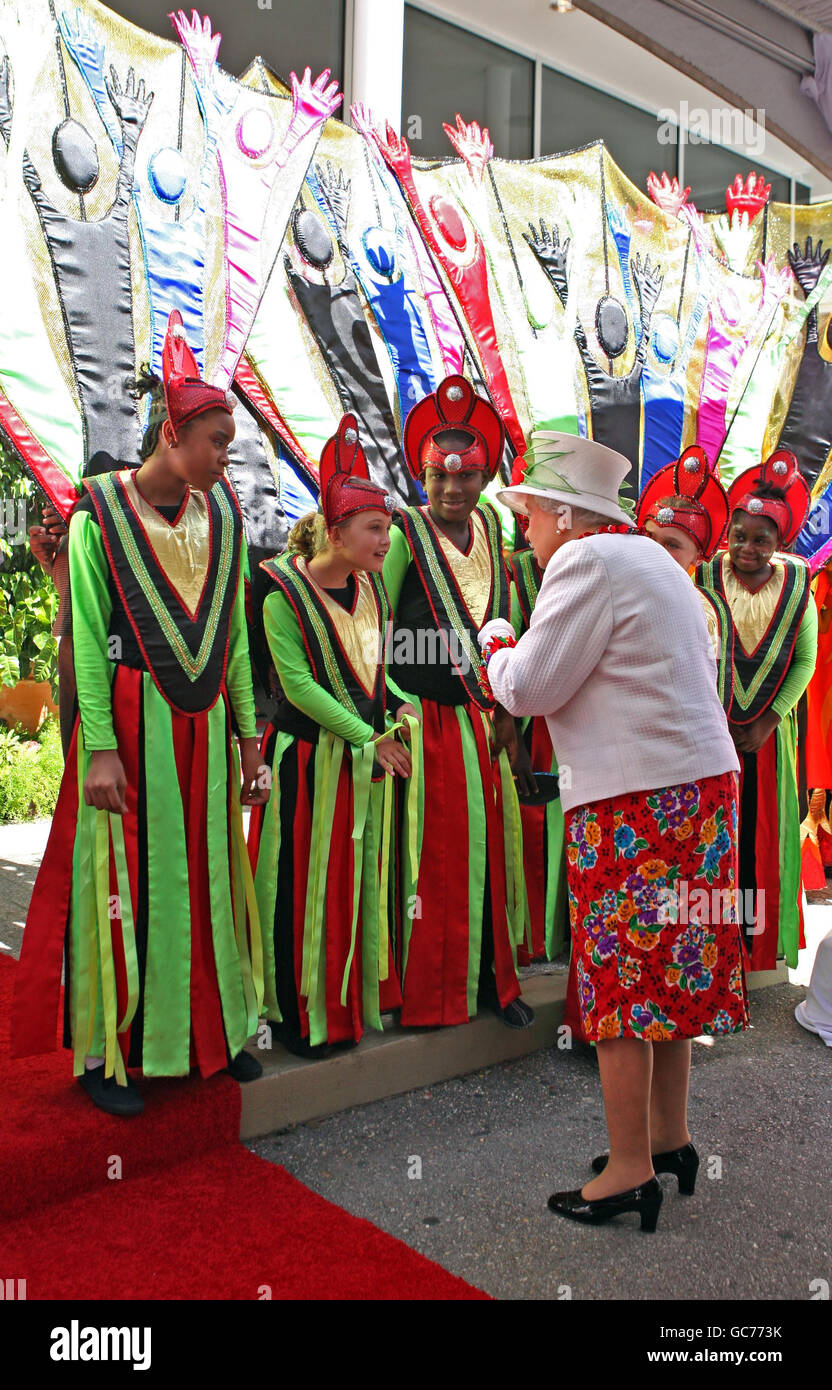 Britain's Queen Elizabeth II is greeted by children dressed in carnival