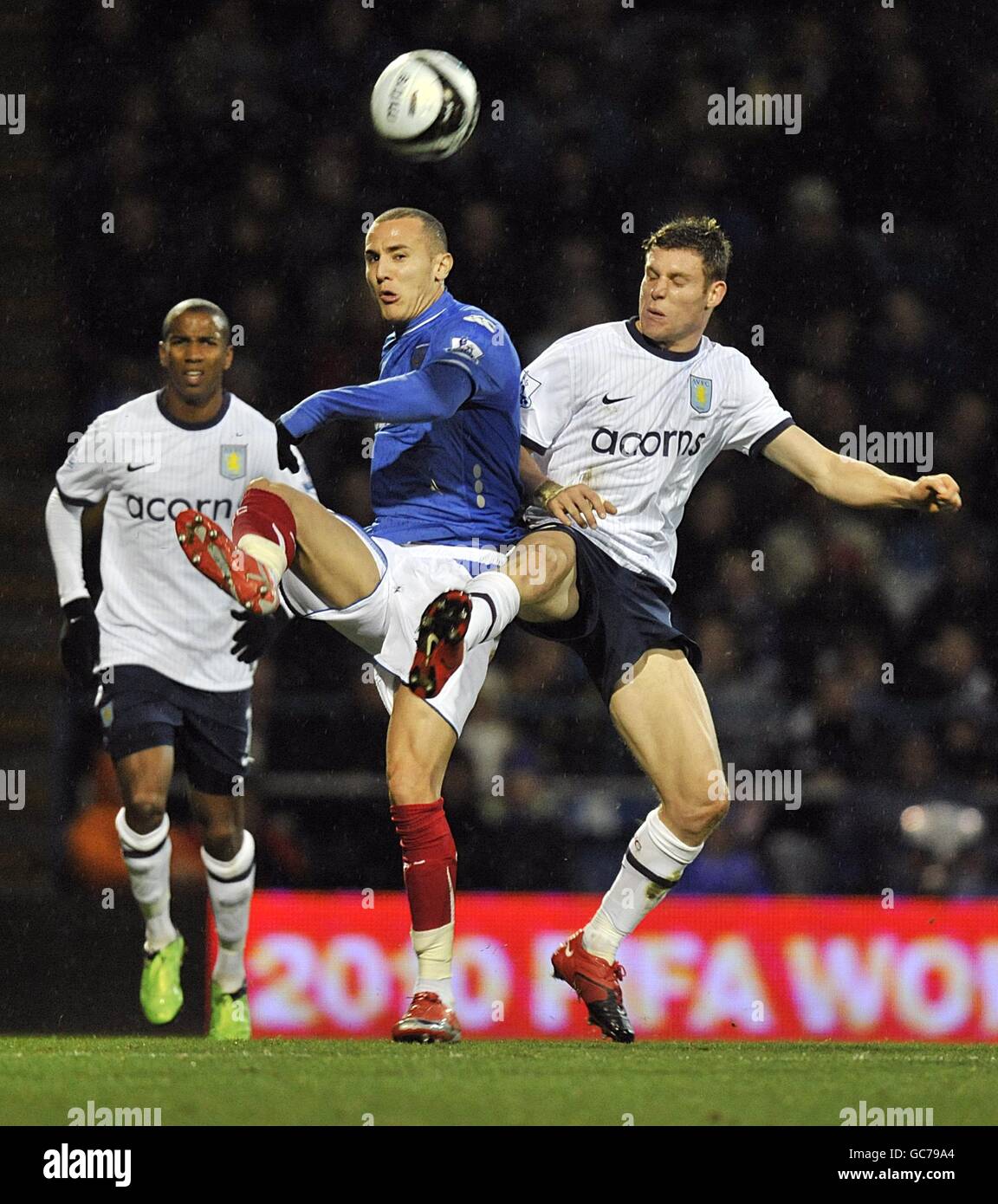 Portsmouth's Hassan Yebda (centre) and Aston Villa's James Milner (right) battle for the ball. Stock Photo