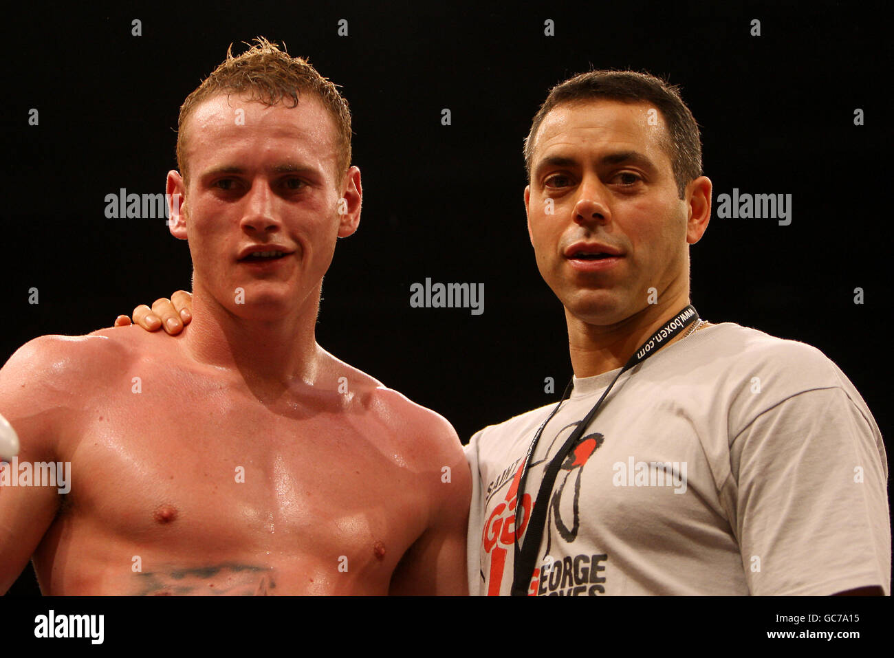 England's George Groves (left) celebrates victory against Bulgaria's Konstantin Makhankov with manager of David Haye, Adam Booth Stock Photo