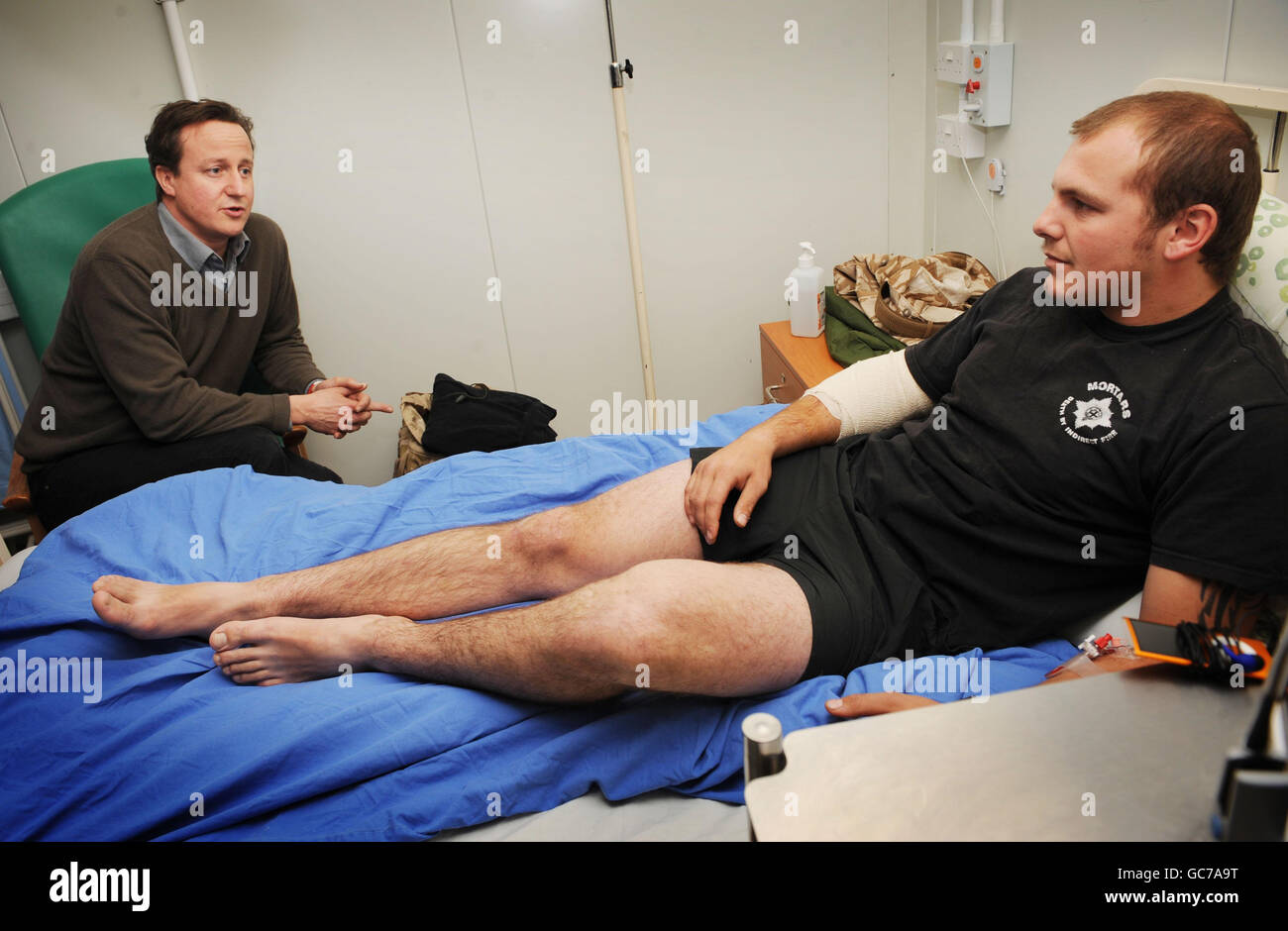 Conservative Party leader David Cameron meets Guardsman Callum Acton, Hull who was shot in the arm, at the Camp Bastion field hospital in Helmand Province, Afghanistan. Stock Photo