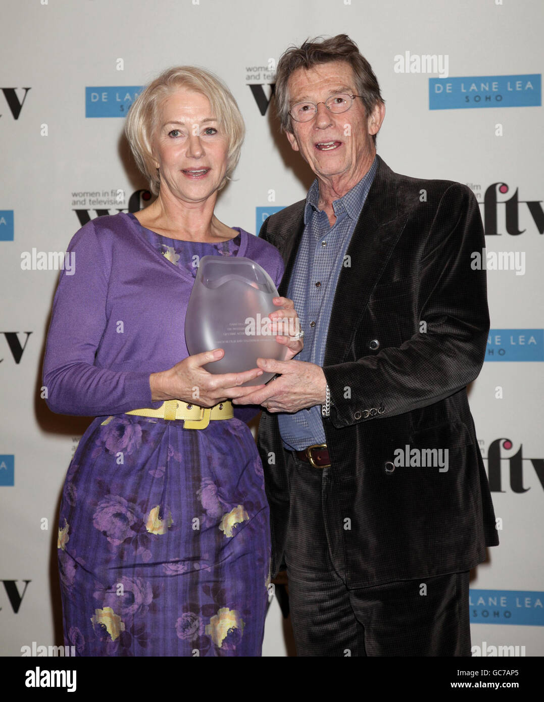 Dame Helen Mirren with the Working Title Films Lifetime Achievement Award, which was presented to her by John Hurt, at the Women in Film and Television Awards luncheon at the Park Lane Hilton, central London. Stock Photo