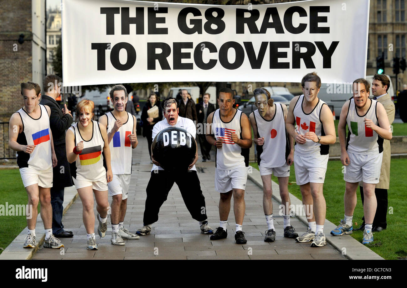 People wearing masks of the G8 leaders pretend to race while the Gordon Brown masked competitor is burdened with debt in a photocall staged by the Tory party, outside the Houses of Parliament, to suggest that Britain is losing the race to recover from the global economic downturn. Stock Photo