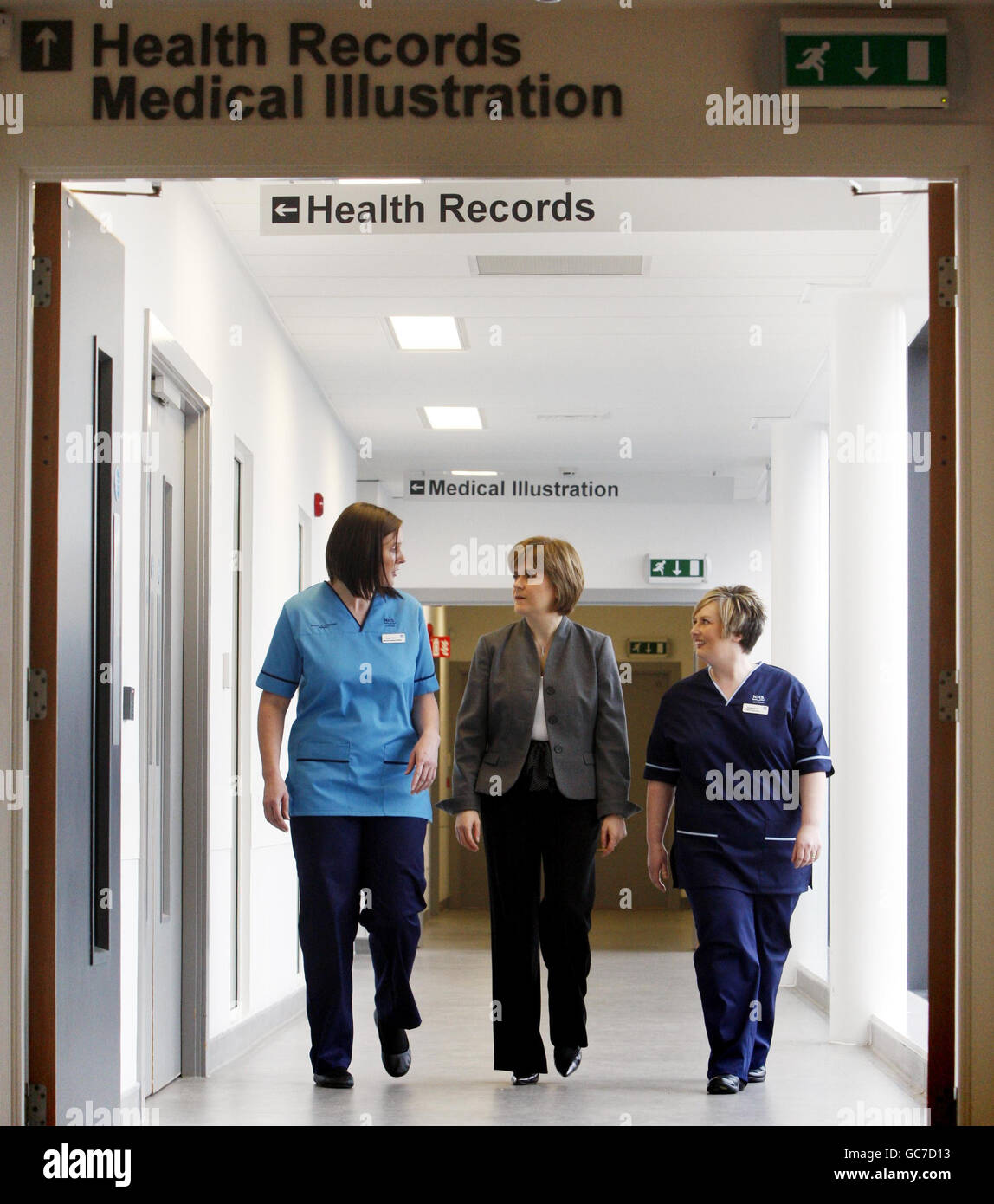 Health Secretary Nicola Sturgeon (centre) chats with Speech and Language Therapist Natalie Turner (left) and Senior Charge Nurse Pamela Burns (right), who are wearing their new national uniforms, during a visit to the New Stobhill Hospital in Glasgow to launch of the new NHS Scotland national uniforms. Stock Photo
