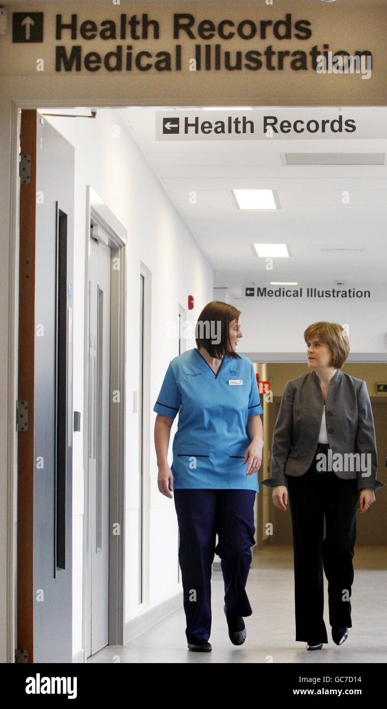 Health Secretary Nicola Sturgeon chats with Speech and Language Therapist Natalie Turner during a visit to the New Stobhill Hospital in Glasgow to launch of the new NHS Scotland national uniforms. Stock Photo