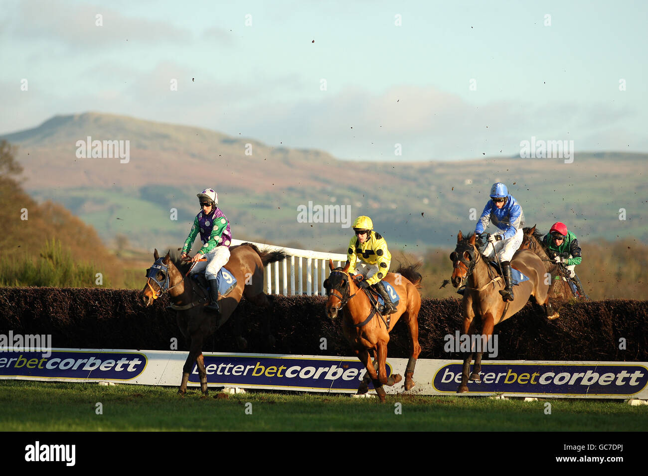 Horse Racing Ludlow Racecourse. Horses and riders clear a fence