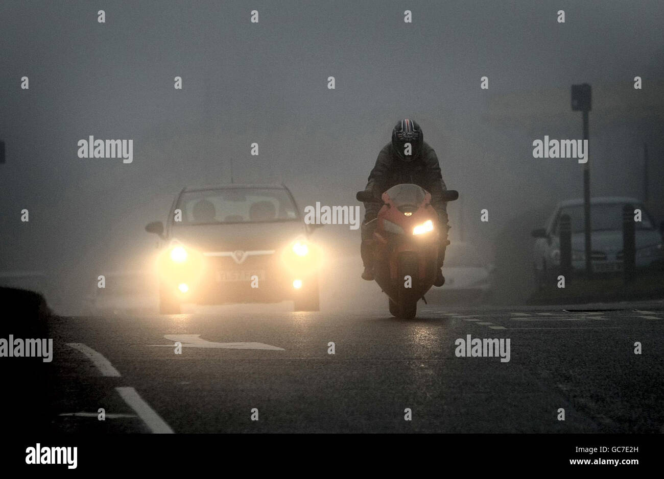 Car drivers use their fog lights today on the M6, with decreased visibility as high pressure sits over the country, covering the roads in fog. Stock Photo