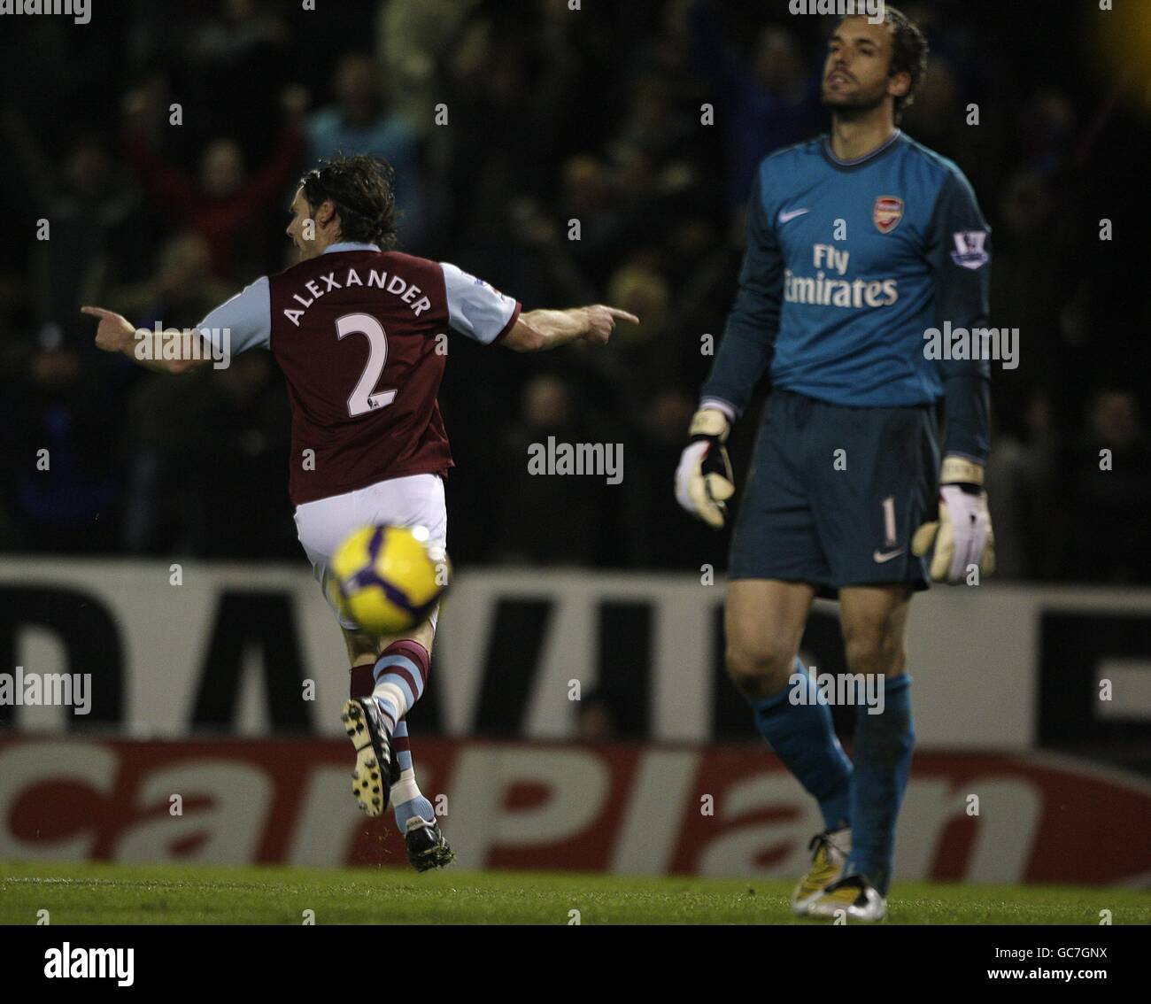 Arsenal goalkeeper Manuel Almunia (right) stands dejected as Burnley's Graham Alexander (left) scores his sides equalising goal from the penalty spot Stock Photo