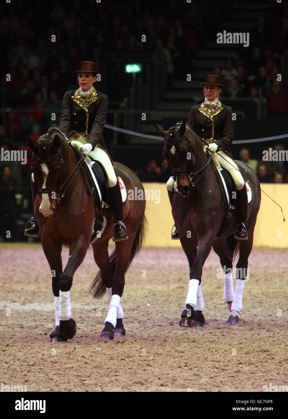 Toni Terry (left) wife of Chelsea and England Captain John, performs dressage with her trainer Vicki Thompson Winfield during the London International Horse Show at the Olympia Exhibition Centre, London. Stock Photo