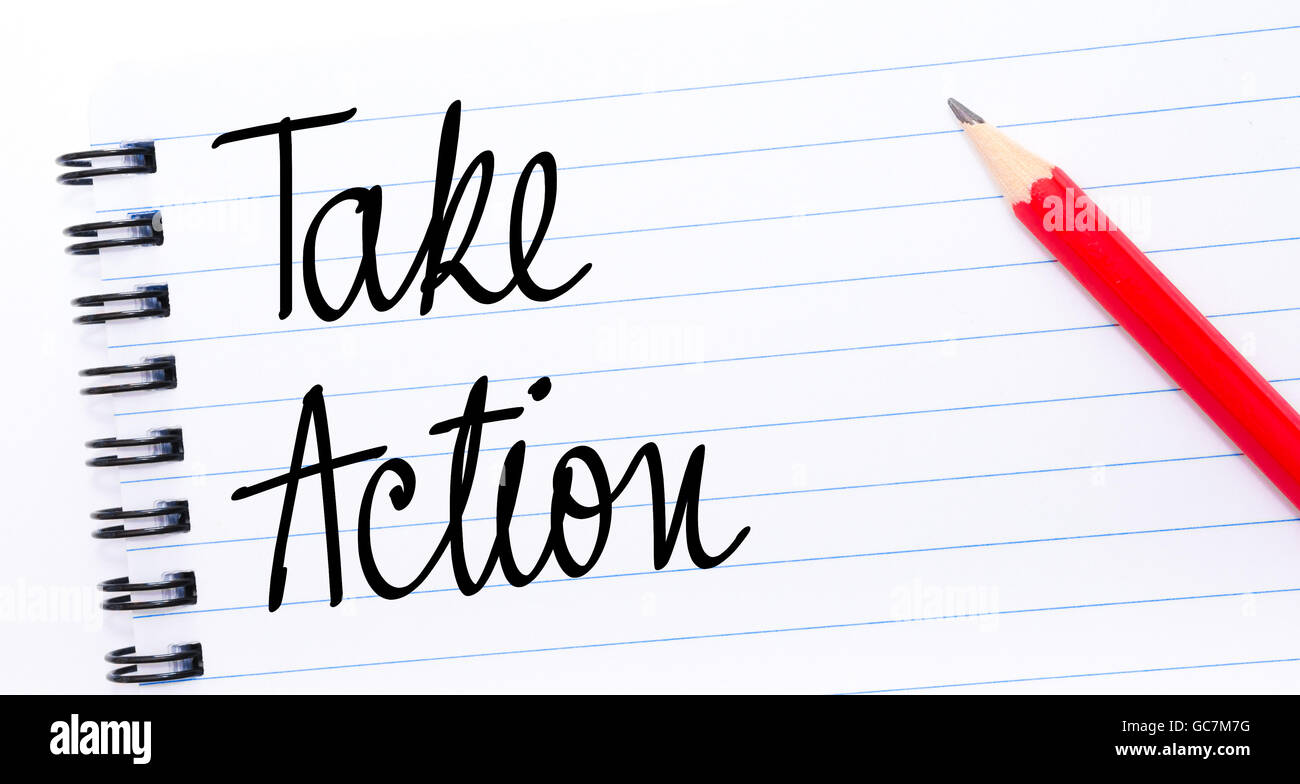 Take Action written on notebook page with red pencil on the right Stock Photo