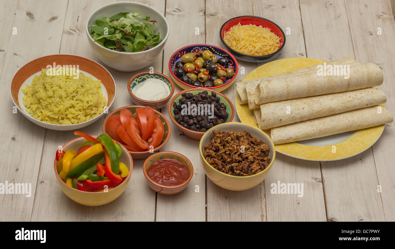 Variety of ingredients to make mexican burritos with tortillas, rice