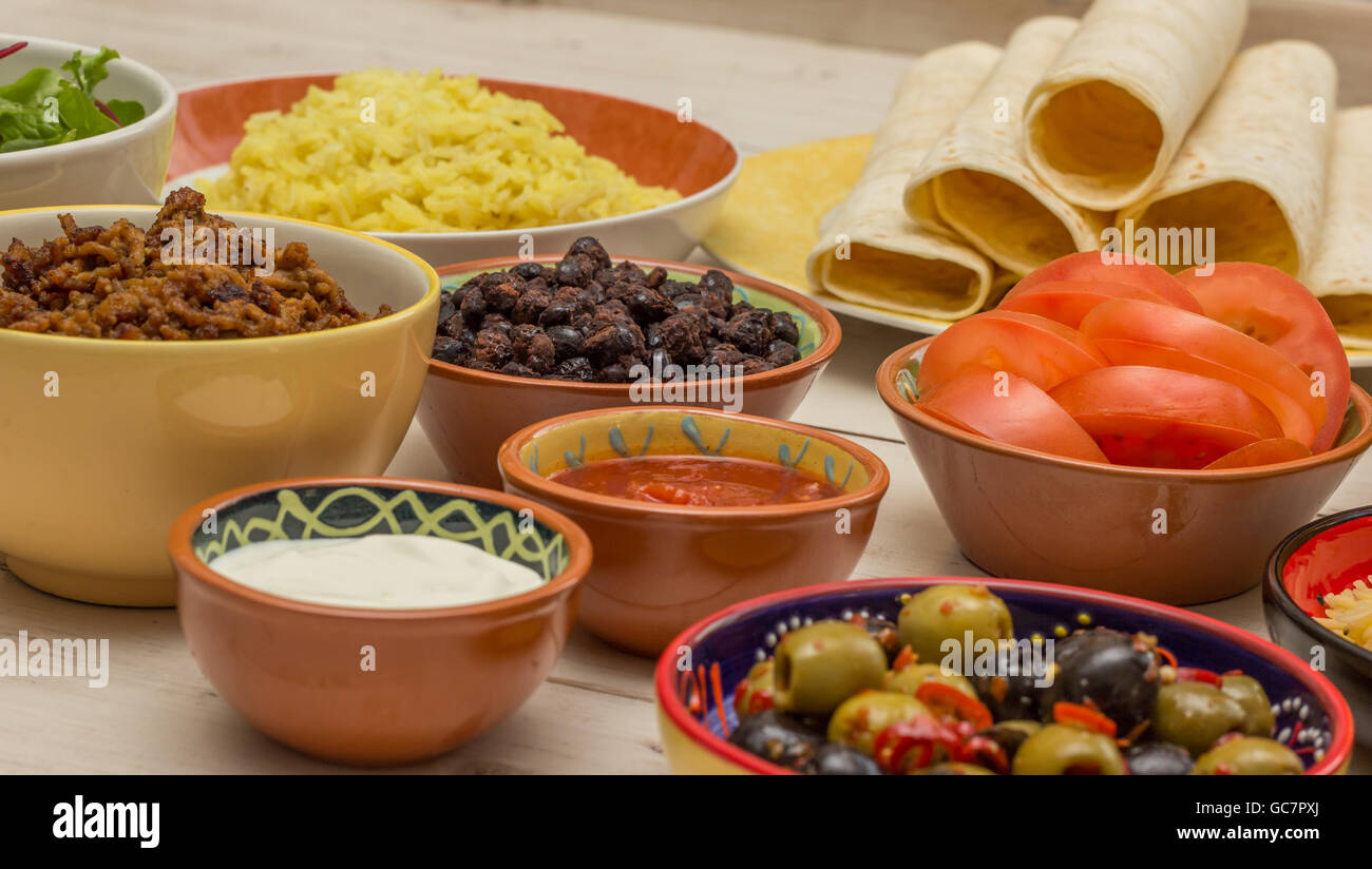 Variety of ingredients to make mexican burritos with tortillas, rice