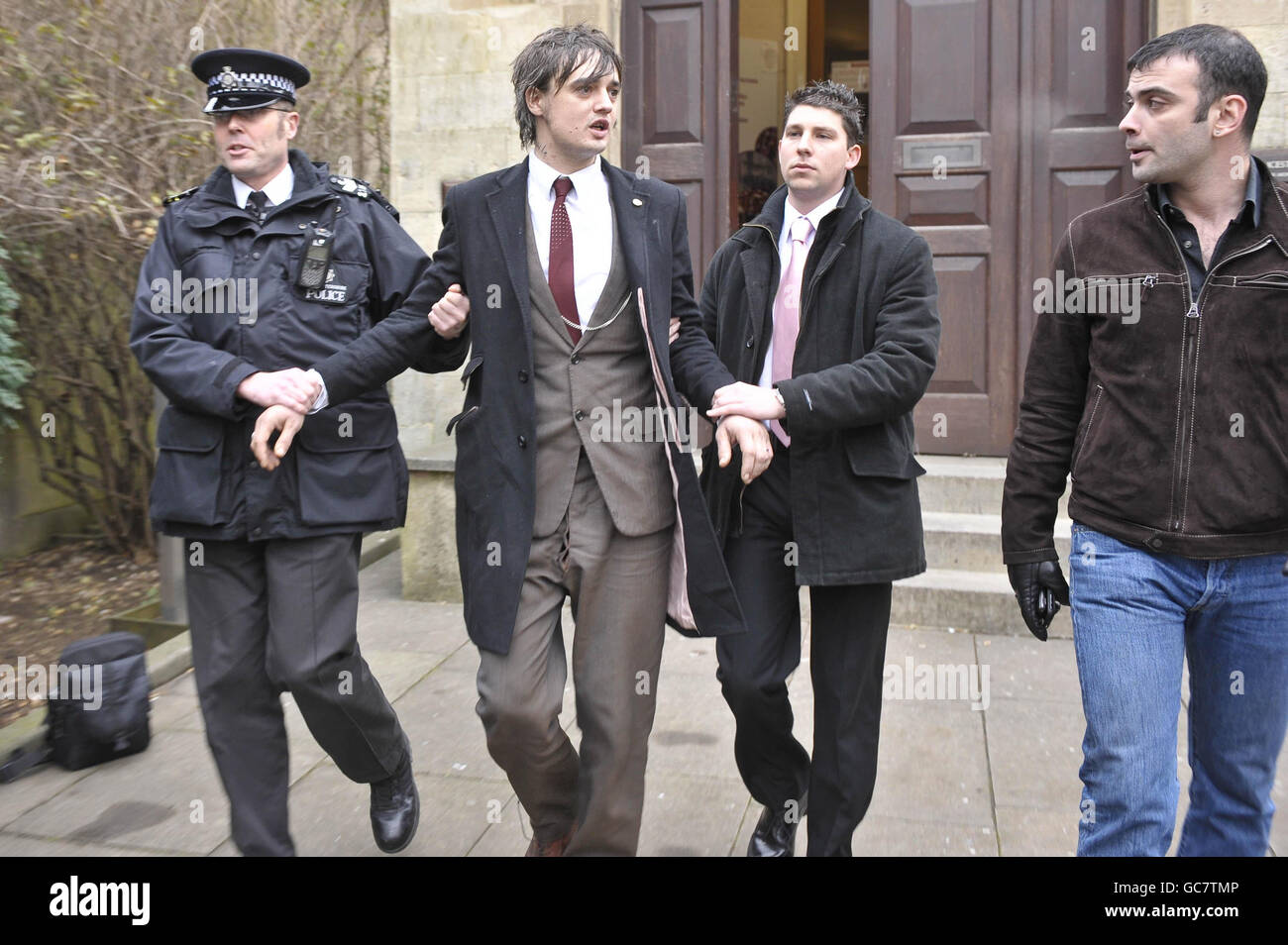 Pete Doherty is led away by police (for reasons unknown) after appearing at Gloucester Crown