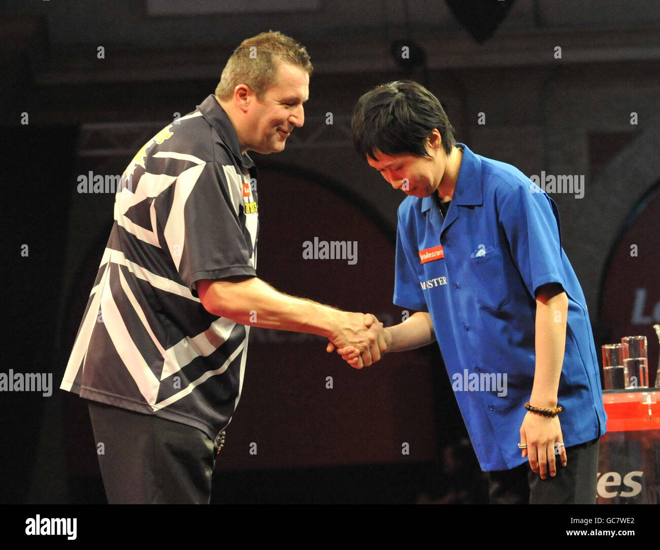 A victorious Ronnie Baxter commiserates Japan's Haruki Muramatsu (right