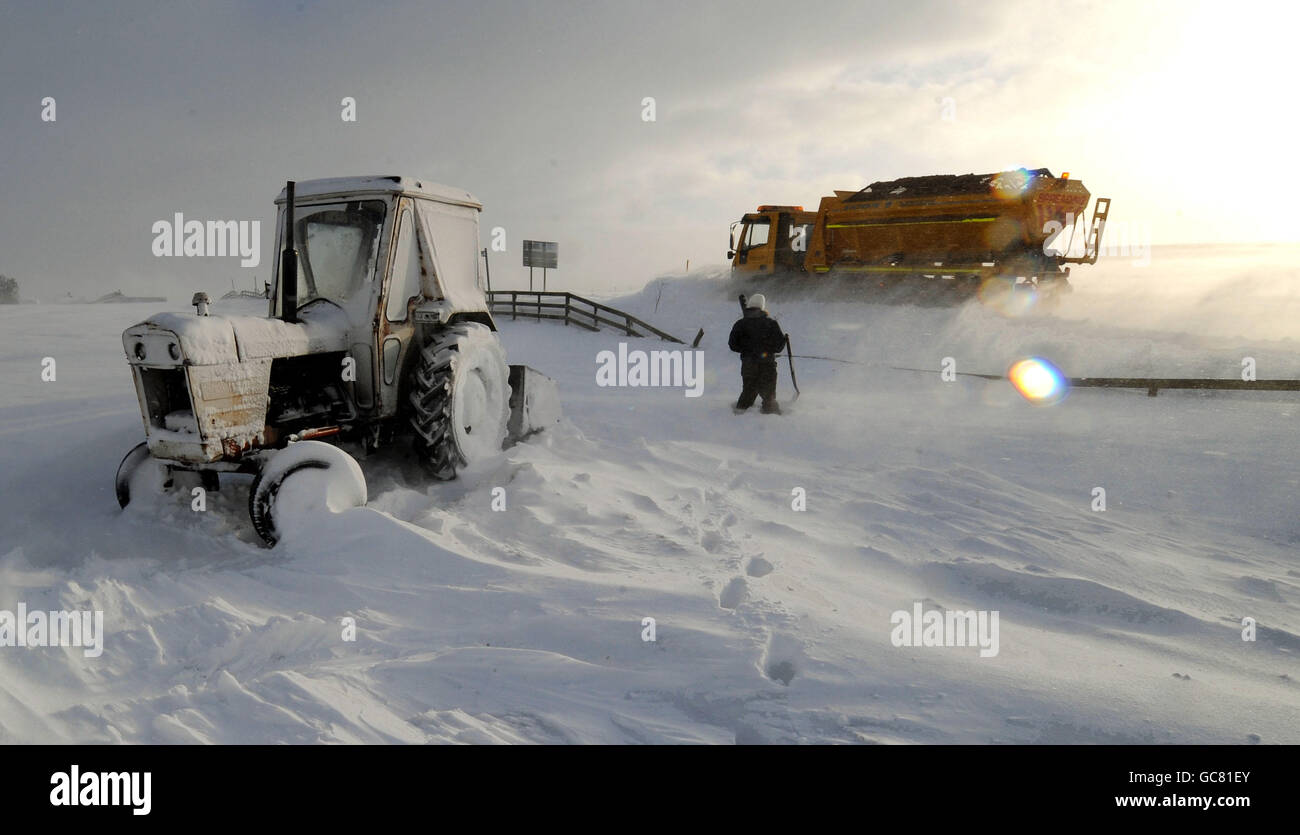A farmer and his tractor in Denshaw near Oldham, as heavy snowfall continues across most parts of the UK. Stock Photo
