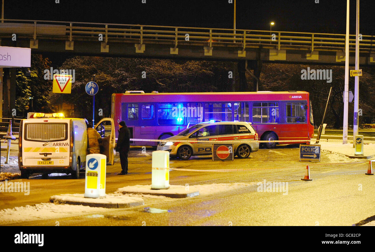 A single decker bus blocks the entrance to Gallows Corner roundabout in Gidea Park, Essex caused by icy roads after a day of heavy snow through out the UK. Stock Photo