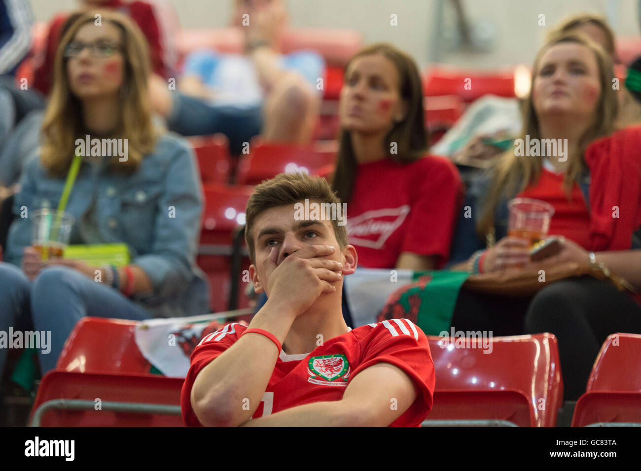 Dejected Wales football supporters watch Wales lose against Portugal in the Euro 2016 semi finals. Stock Photo