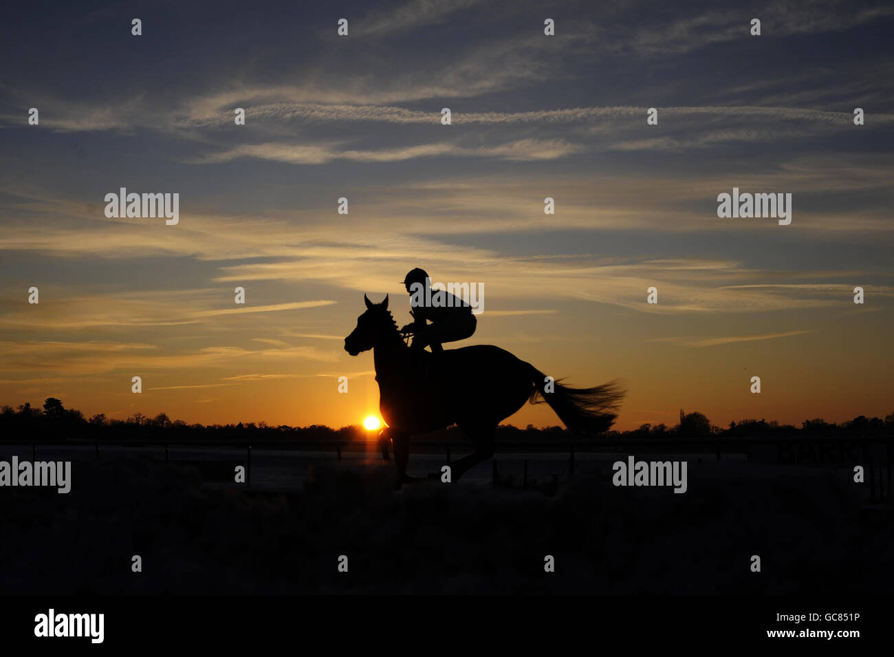 Horse Racing - Lingfield Racecourse. A runner goes to post for the last race as the sun sets at Lingfield Racecourse, Lingfield. Stock Photo