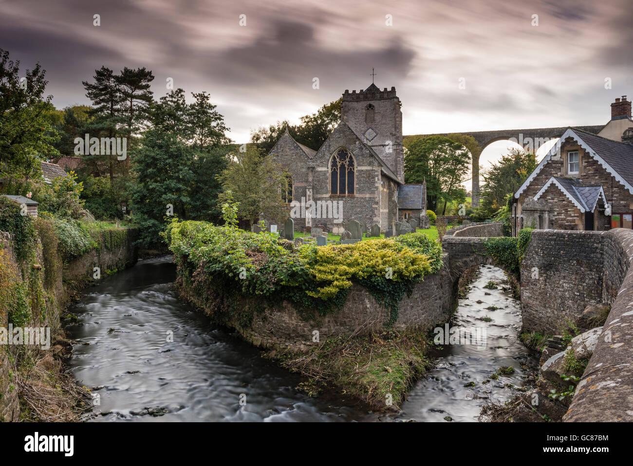 St Thomas à Becket Church with Pensford Viaduct in the background, Pensford, Somerset, UK Stock Photo