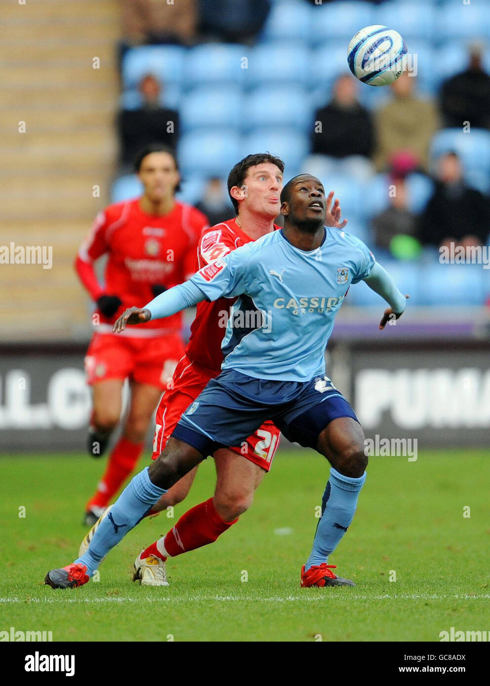 Coventry's Leon Barnett (right) and Barnsley's Jon Macken battle for the ball during the Coca-Cola Championship match at The Ricoh Arena, Coventry. Stock Photo