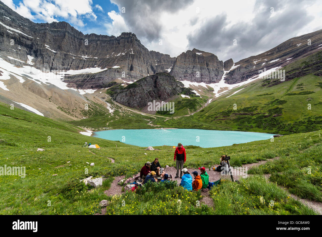 Campers along the glacial blue Cracker Lake at Glacier National Park in West Glacier, Montana. Stock Photo