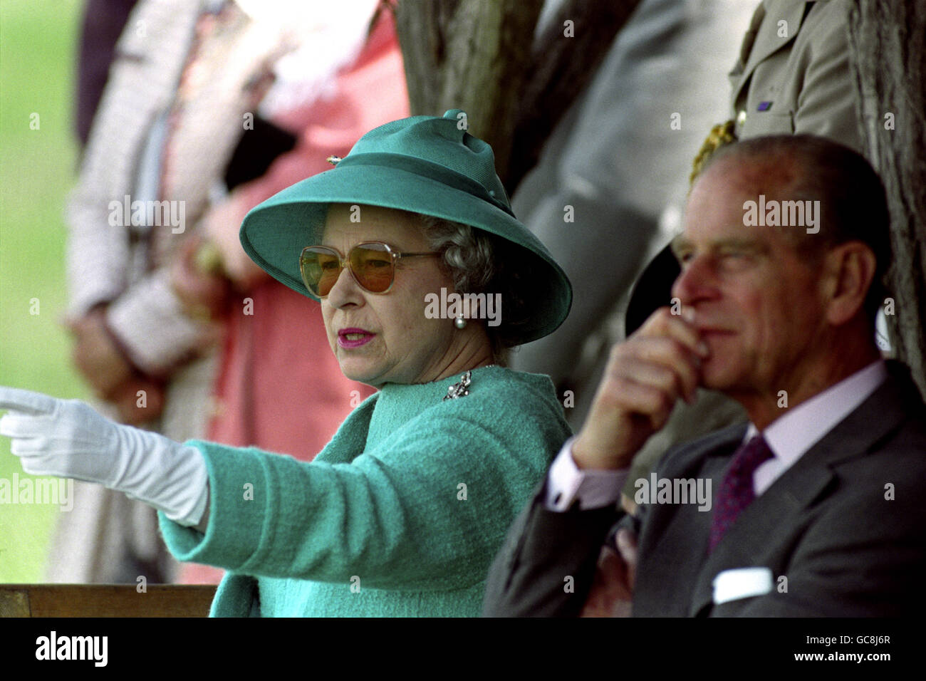 WE ARE AMUSED ...BRITAIN'S QUEEN ELIZABETH II LAUGHS AS SHE WATCHES A DISPLAY OF TRADITIONAL SKILLS BY HUNGARIAN HORSEMEN ON THE PLAINS AT BUGAC. THE QUEEN AND PRINCE PHILIP HAD ARRIVED AT THE DISPLAY IN A HORSE-DRAWN CARRIAGE FROM A NEARBY PICNIC. Stock Photo