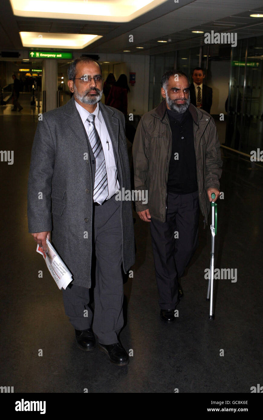 Brothers Soohail (left) and Nasir Shaikh at London's Heathrow Airport as they return from China following an unsuccessful bid to avert the execution of their cousin Akmal Shaikh who was convicted of smuggling 4kg (8.8lb) of heroin into the country. Stock Photo